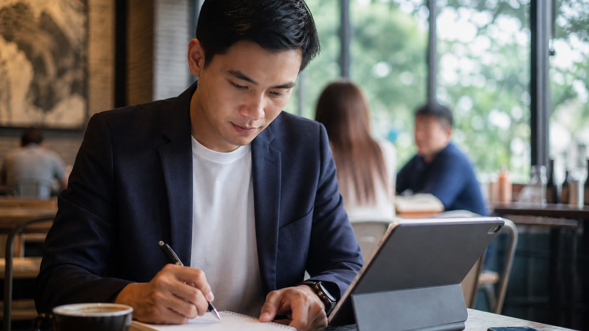 Job candidate preparing interview answers about skills that align with a resume and job posting on a laptop